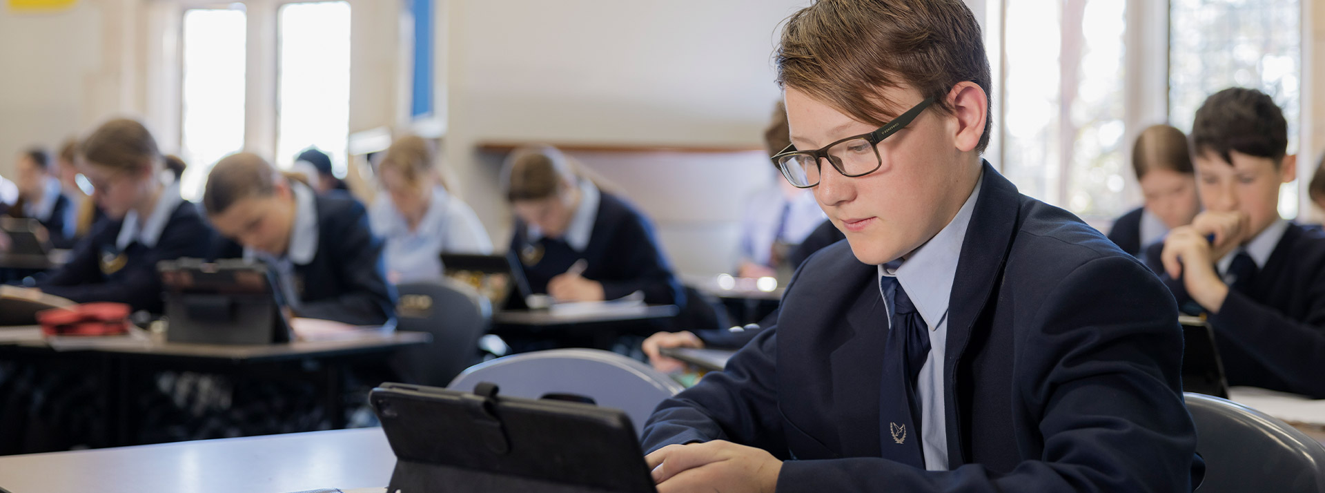 Student using his iPad in the classroom at St Columba’s Catholic College Springwood