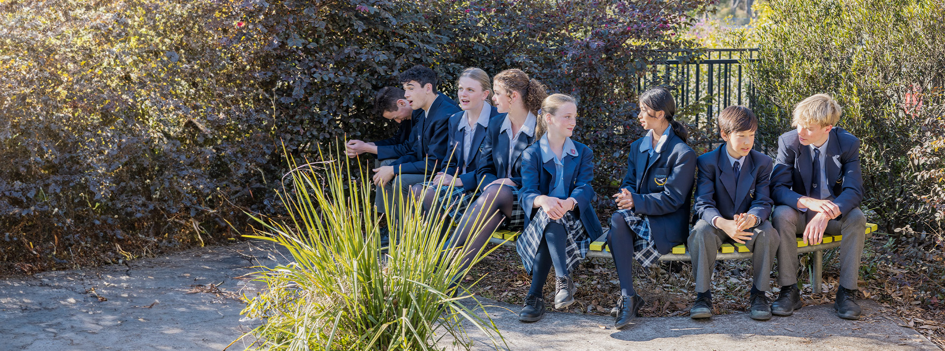 Students sitting together in the school grounds at St Columba’s Catholic College Springwood