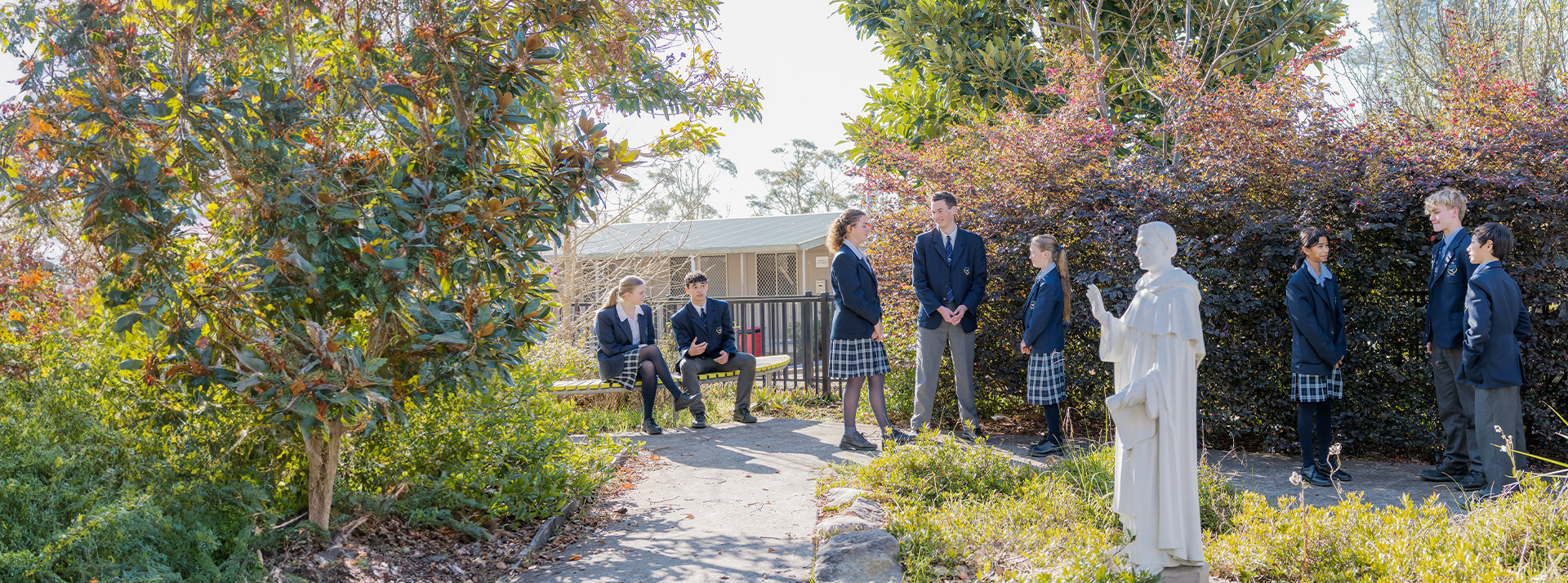 Students standing together in the school garden at St Columba’s Catholic College Springwood