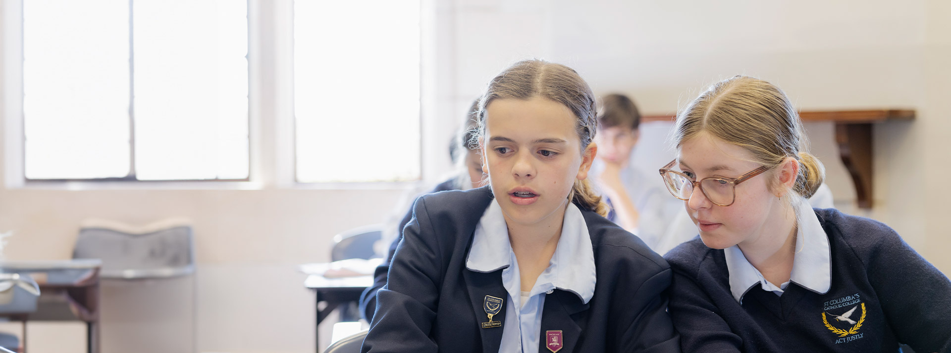Students working together at their desks in the classroom at St Columba’s Catholic College Springwood