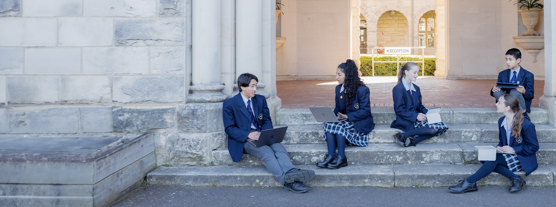 Students reading on the steps at St Columba’s Catholic College Springwood