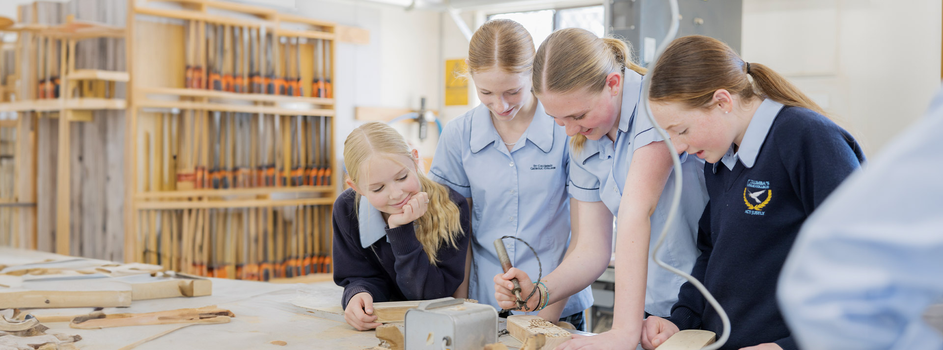 Students in the woodwork room engraving timber at St Columba’s Catholic College Springwood
