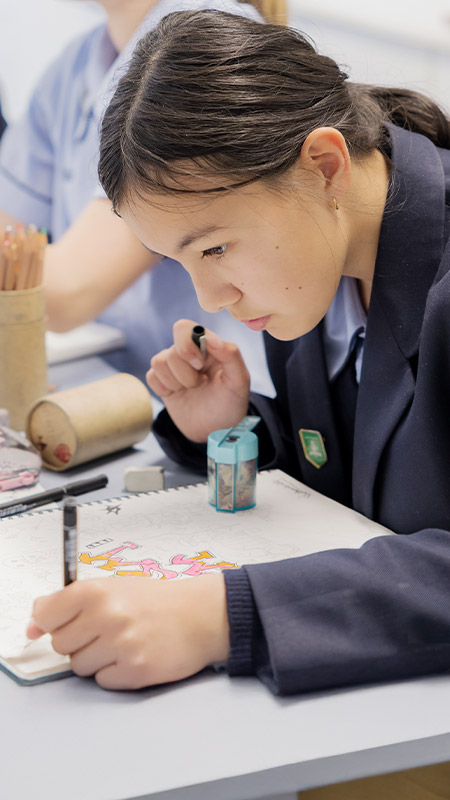 Student working on her artwork in the classroom at St Columba’s Catholic College Springwood