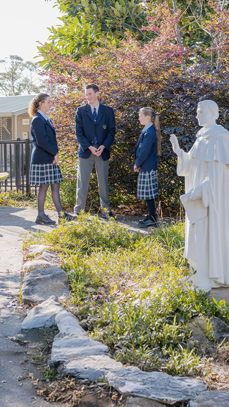 Students standing together in the school garden at St Columba’s Catholic College Springwood