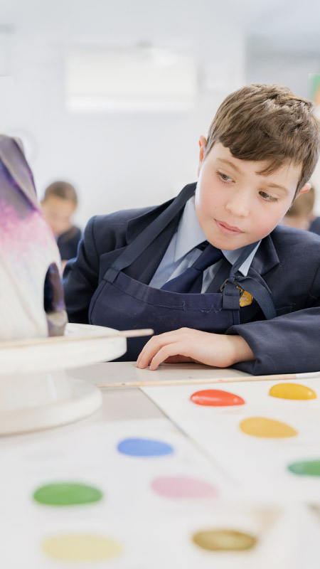 Student working on his art project in the classroom at St Columba’s Catholic College Springwood