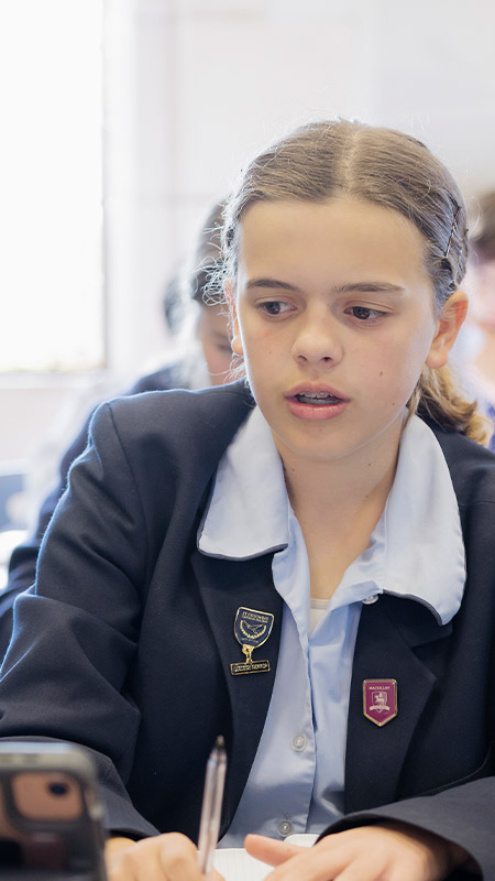 Students working together at their desks in the classroom at St Columba’s Catholic College Springwood