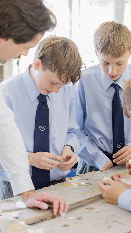 Student working with students in the classroom at St Columba’s Catholic College Springwood