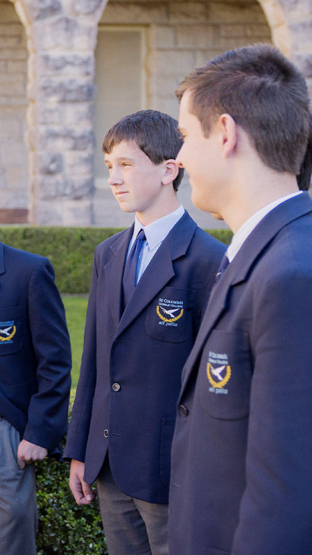 Principal Phillip Scollard with students in the school grounds at St Columba’s Catholic College Springwood