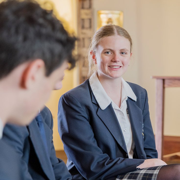 Student smiling in the chapel at St Columba’s Catholic College Springwood
