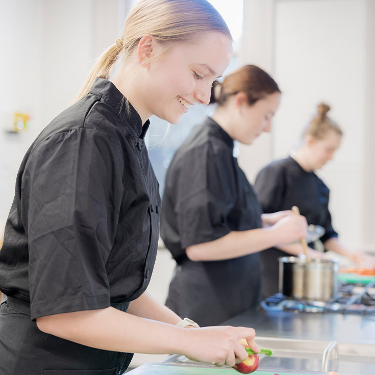 Students preparing food in the school kitchen at St Columba’s Catholic College Springwood